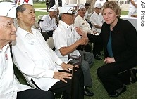 Karen Hughes chats with Filipino World War II veterans following wreath-laying ceremony in Manila, 26 Jan. 2007