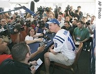 Indianapolis Colts quarterback Peyton Manning is surrounded by reporters and photographers as he answers questions at a media availability, 1 Feb 2007 