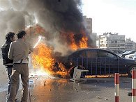 Two Lebanese pro-government supporters, extinguish a burning car after confrontations erupt between government and opposition supporters in Beirut, 25 Jan 2007