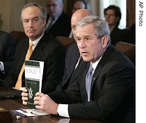 President Bush, right, holds up copy of fiscal 2008 federal budget at end of Cabinet meeting, 5 Feb. 2007 