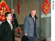 Christopher Hill, right, arrives in Beijing, 7 Feb. 2007