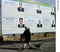 Turkmen woman passes election posters with candidates in Turkmen capital of Ashgabat, 7 Feb 2007