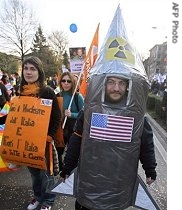 A demonstrator dressed as a nuclear missile protests against the planned expansion of the US military base near the Dal Molin airport, in Vicenza, Italy