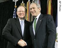 President Bush, (r), shakes hands with Director of National Intelligence Mike McConnell during swearing-in ceremony at Bolling Air Force Base in Washington DC, 20 Feb 2007