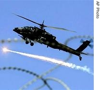 U.S. military Apache helicopter releases an anti missile decoy flair as it files over Baghdad, 15 Feb 2007