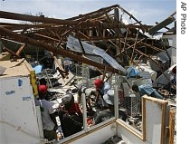 Residents salvage goods from a department store in the Mozambique coastal town of Vilankulo Saturday Feb. 24, 2007