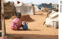 Young girl washes plates for her family in North Darfur refugee camp of El Sallam 