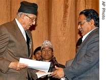 Nepal's Prime Minister Girija Prasad Koirala, left, and Maoist rebel leader Prachanda exchange signed peace accords in Katmandu, Nepal, Nov. 21, 2006