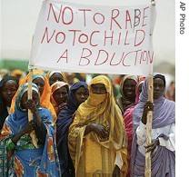 Sudanese refugee woman hold a sign saying no to rape (File photo)  