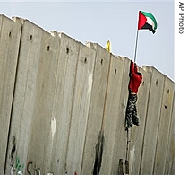 A Palestinian youth climbs the separation barrier during clashes with Israeli troops at the Kalandia Checkpoint between Jerusalem and the West Bank town of Ramallah, 09 Mar 2007