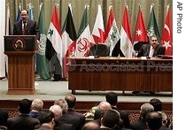 The Iraqi Prime Minister Nouri al-Maliki, left, addresses the Baghdad peace conference, while the country's Foreign Minister Hoshyar Zebari looks on