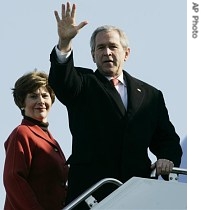 President Bush, right, accompanied by first lady Laura Bush, waves prior to boarding Air Force One at Andrews Air Force Base in Maryland