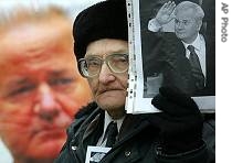 An admirer of late Serbian president Slobodan Milosevic holds his portrait during a rally to mark the first anniversary of his death in downtown Moscow, 11 March 2007