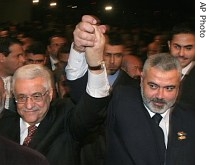 Palestinian Authority President Mahmoud Abbas, left, and Prime Minister Ismail Haniyeh from Hamas, right, raise their linked arms as they move through the crowd at a special session of parliament in Gaza City 17 Mar 2007