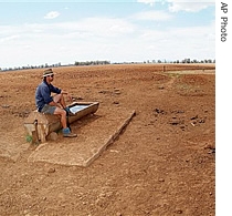 Farmer Andrew Higham looks over his parched land in north western New South Wales, 14 Oct 2006