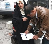An Iraqi refugee and his wife view registration papers in front of the offices of the UNHCR in Damascus, Syria before registering at the agency, 11 Feb 2007