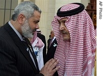 Palestinian Prime Minister Ismail Haniyeh, left, talks to Saudi Foreign Minister Saud Al-Faisal after the opening session of the Arab Summit in Riyadh