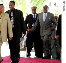 Zimbabwe's President Robert Mugabe, right, arrives at the extraordinary meeting of the Southern African Development Community in Dar es Salaam, 29 Mar 2007 