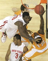 Ohio State's Greg Oden, center, tries to block the shot of Tennessee's Ramar Smith (12) as Dane Bradshaw, top, watches during their NCAA South Regional semifinal, 22 Mar 2007
