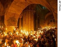 Christian Orthodox worshippers pray and hold candles at the Church of the Holy Sepulcher, 07 Apr 2007