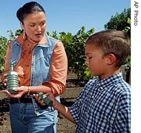 Heidi Kuhn, center, of Roots of Peace, and Kuhn's son, Christian Kuhn, look over some inert land mines in California (File)