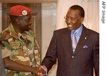 Chad's President Idriss Deby (R) shakes hands with rebel leader of the United Front for Change (FUC) Mahamat Nour Abdulkerim (L) in Libya, 24 Dec 2006