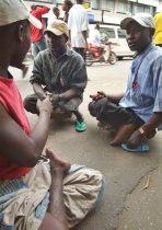 Lawal Manesara, left, discuss with Ali Usman, centre, and sani Bako, right, all polio victims in a street of Lagos, Nigeria, 4 May 2005<br />