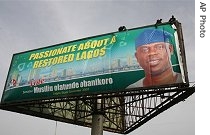 Workers install an election poster for Musiliu Obanikoro, the Lagos state governor candidate for the ruling People's Democratic Party (PDP) in Lagos, Nigeria, 10 Apr 2007