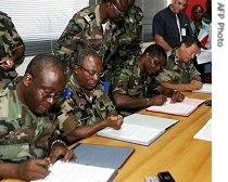 (L to R) General Amoussou Marcel, General Bakayoko Soumaila, head of New Forces rebels party, General Mangou Philippe, Ivory Coast chief of Staff and French general Antoine Lecerf sign an agreement, 11 Apr 2007