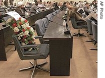 Flowers are placed at chair of parliament member Mohammed Awad, who was killed in a suicide bombing Thursday, during special parliament session in Baghdad, 13 Apr 2007