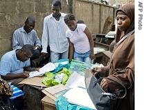 Officials from Independent National Electoral Commission sort out material being taken to polling centres in Lagos, 14 Apr 2007