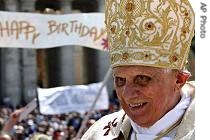A giant birthday banner is seen in the background as Pope Benedict XVI is driven through the crowd at the end of his birthday Mass at the Vatican, 15 Apr 2007