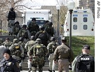 SWAT team members head to Norris Hall, the site of a shooting on campus of Virginia Tech in Blacksburg, Virginia, 16 Apr 2007