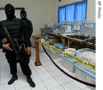 Members of the Indonesian Police Anti-Terror Department stand near evidence confiscated in last month's raids on a terrorist hideout, in Yogyakarta, central Java, Indonesia, 03 Apr 2007