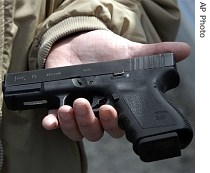 Roanoke Firearms owner John Markell holds a Glock 9 mm pistol similar to the one sold in his gun shop 36 days ago to the Virginia Tech shooting suspect Cho Seung-Hui