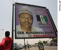 A Nigerian stands near a poster with the picture of Muhammadu Buhari who is a presidential candidate of the All Nigerian people's party (ANPP) in Kano, 19 Apr 2007