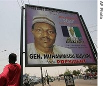 A Nigerian stands near a poster with the picture of Muhammadu Buhari who is a presidential candidate of the All Nigerian people's party (ANPP) in Kano, 19 Apr 2007
