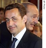 French President Jacques Chirac, right, walks behind French Interior Minister Nicolas Sarkozy (File photo)
