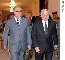 Iraq Minister of Defense Abdel Qader al-Obeidi (L) walks next to US Defense Secretary Robert Gates