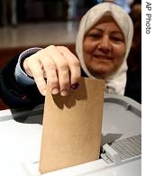 A Syrian woman puts her vote in the ballot box at a polling station in Damascus, Syria, 22 Apr 2007