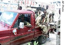 Somali Transitional Federal Soldiers with an anti aircraft gun mounted on the pickup and soldiers carrying AK 47's in the street of Mogadishu, 27 Apr 2007
