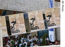 Palestinians gather in front of the Ramallah Cultural Palace to attend the opening ceremony of the Ramallah Film Festival (File)