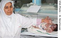A hospital worker with a child in the neonatal unit