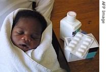 A baby sleeps in her mother's arms next to the anti-AIDS drug nevirapine