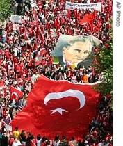 Demonstrators march with Turkish flags a huge poster of modern Turkey's founder Ataturk during a pro-secular rally in Manisa, western Turkey, 5 May 2007