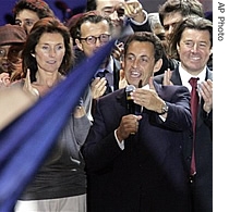 French President elect Nicolas Sarkozy, right, gestures as he delivers a speech before supporters on Concorde square 06 May 2007