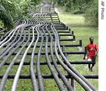 Man walks along oil pipelines belonging to Italian oil company Agip in Obrikom, Nigeria (File)