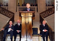 Britain's PM Tony Blair, center, speaks as Northern Ireland's First Minister Ian Paisley, Deputy First Minister Martin McGuinness and Ireland's PM Ahern, seated from left, look on, 8 May 2007