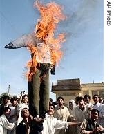 Afghan youths look at an effigy of US President George W. Bush after setting on fire during a protest in Jalalabad, 1 May 2007