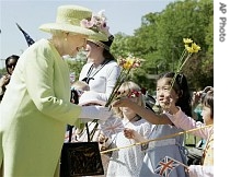 Queen Elizabeth II accepts flowers from children during a visit to NASA's Goddard Space Flight Center 8 May 2007